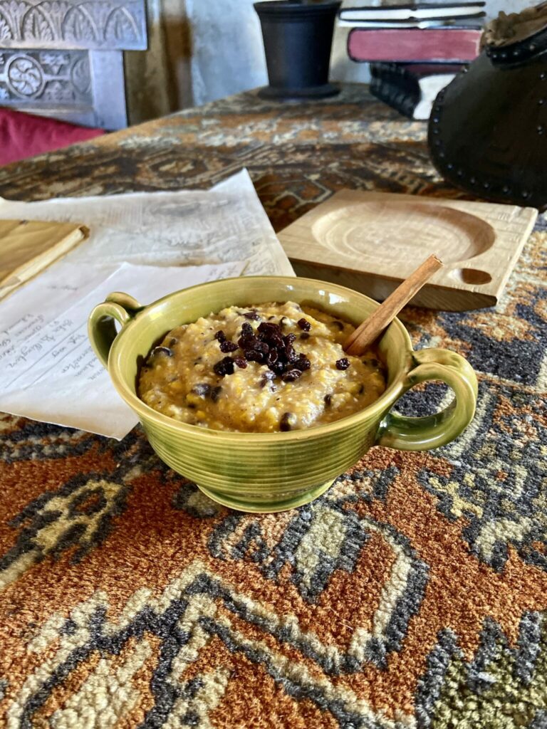 Sweet Corn Pudding in a ceramic bowl on a wooden table.